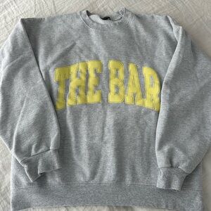 The Bar Gray Sweatshirt with Pale Yellow Lettering